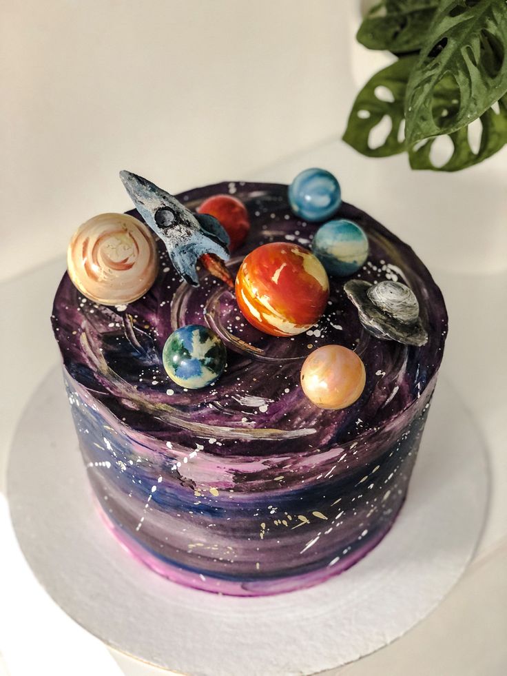 a cake with planets on it sitting on top of a table