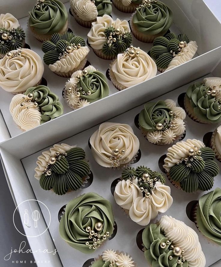 cupcakes with green and white frosting in a box next to each other