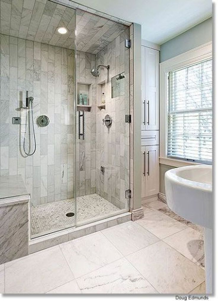 a bathroom with a walk in shower next to a sink