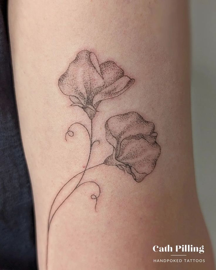 a woman's thigh with a flower tattoo on it