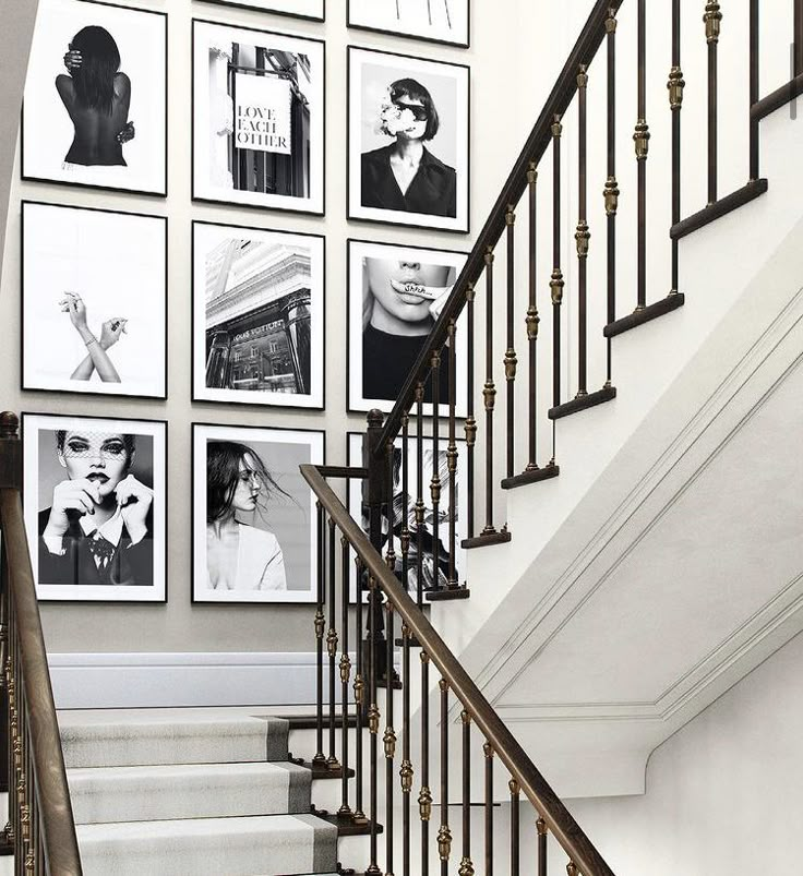 there is a staircase with pictures on the wall and in front of it are stairs