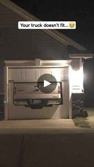 a truck parked in front of a house at night with the door open and lights on