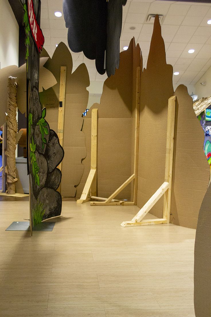 an indoor play area with cardboard walls and climbing equipment