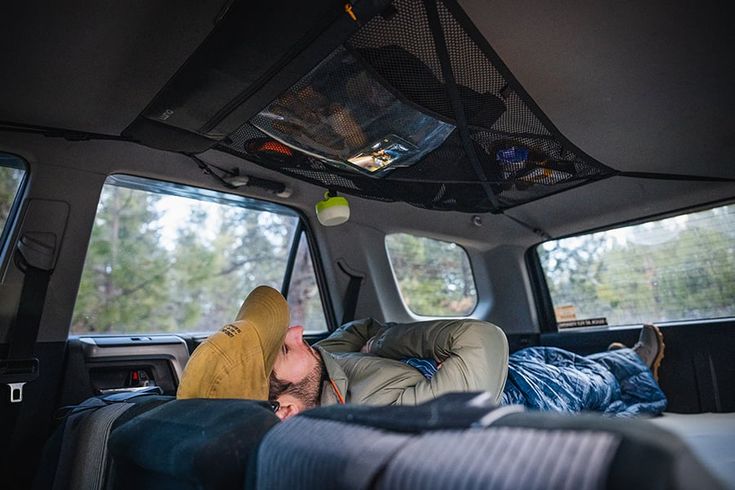 a man sleeping in the back of a truck