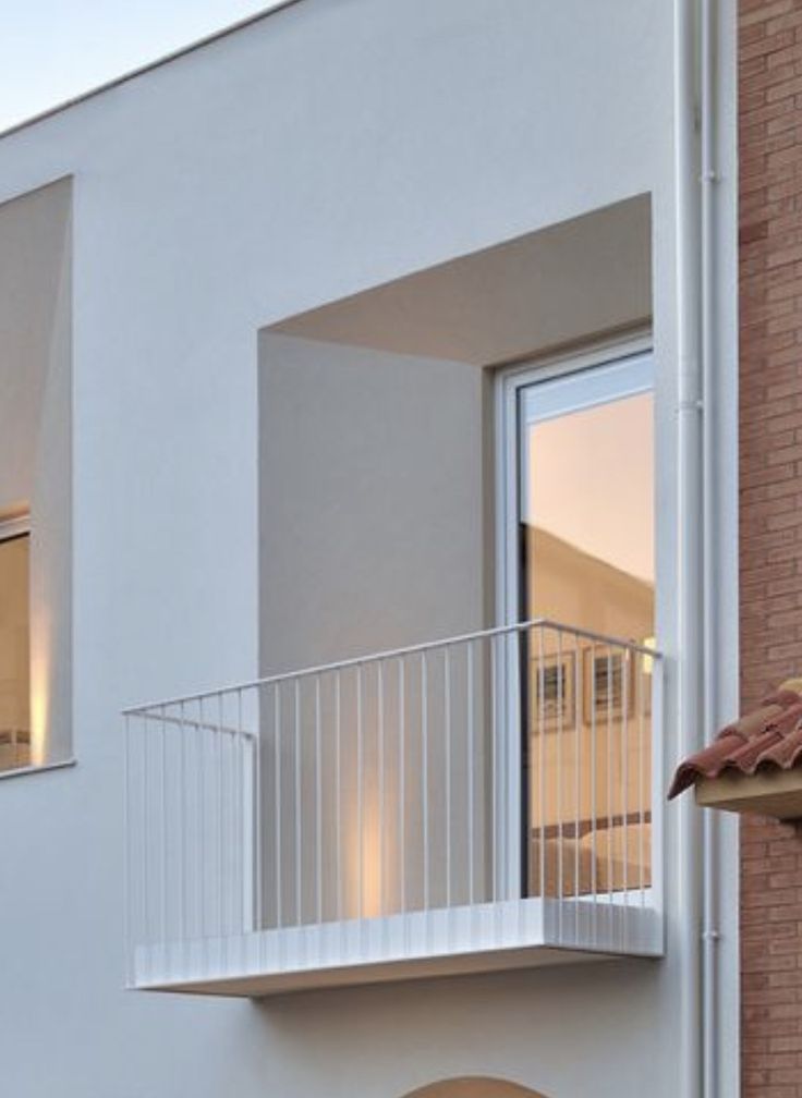 an apartment building with two balconies and a balcony