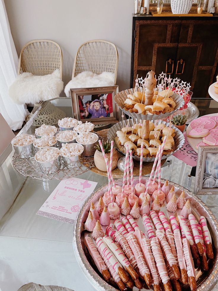 a table topped with lots of food and desserts