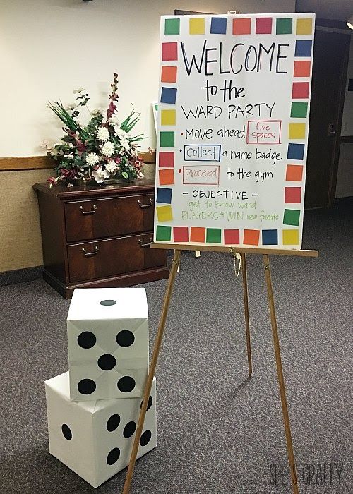 a welcome to the vaed party sign with dices on it in an office