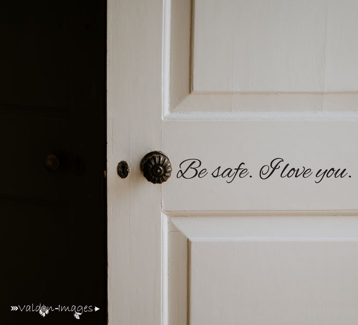 a white door with the words be safe, love you written in black on it