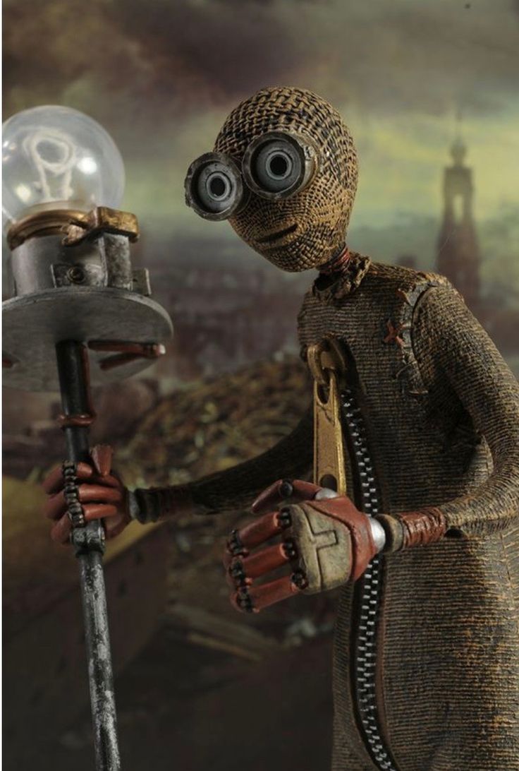 a toy figure with goggles holding a light bulb