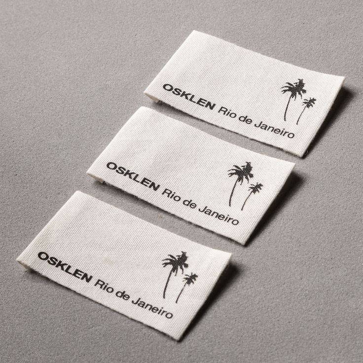 three labels with palm trees on them sitting on top of a gray countertop next to each other