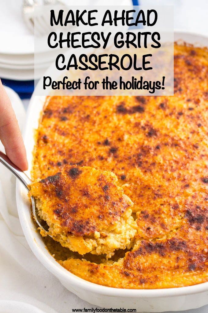 a hand holding a spoon over a casserole in a white dish with the words make ahead cheesy grits casserole perfect for the holidays