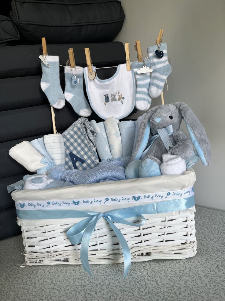 a white basket filled with baby items on top of a table