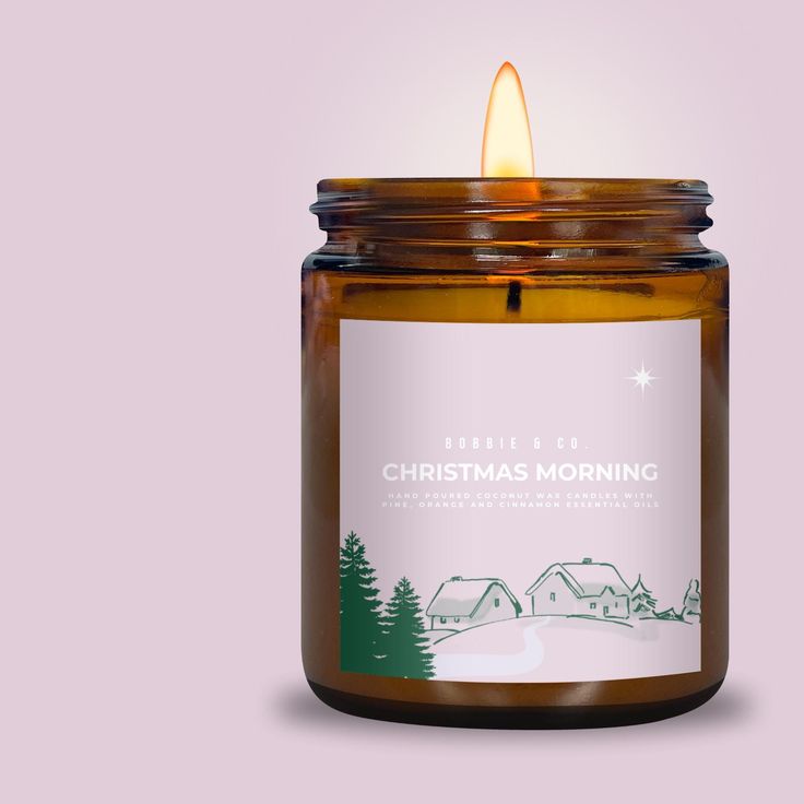 a candle that is sitting in front of a purple background with the words christmas morning on it