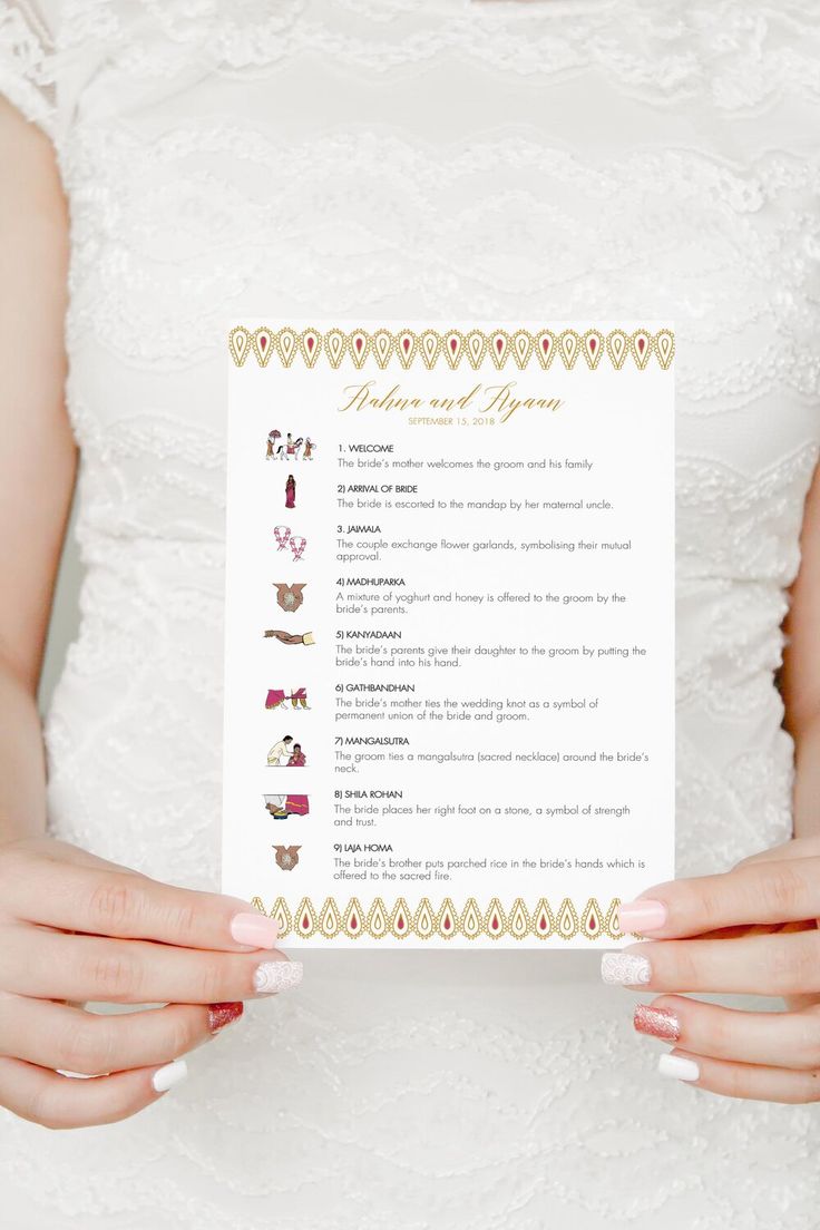 a bride holding up her wedding ceremony program with gold trimmings on the front