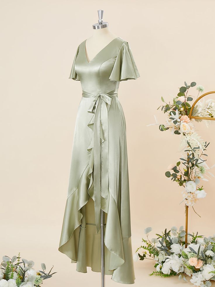 a dress on a mannequin next to flowers