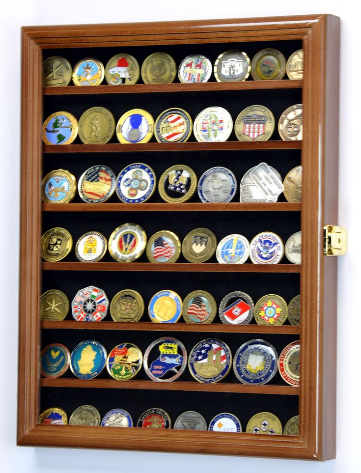 a wall mounted display case filled with lots of badges