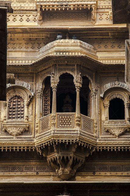 an ornate balcony and balconies on the side of a building with carved stone work