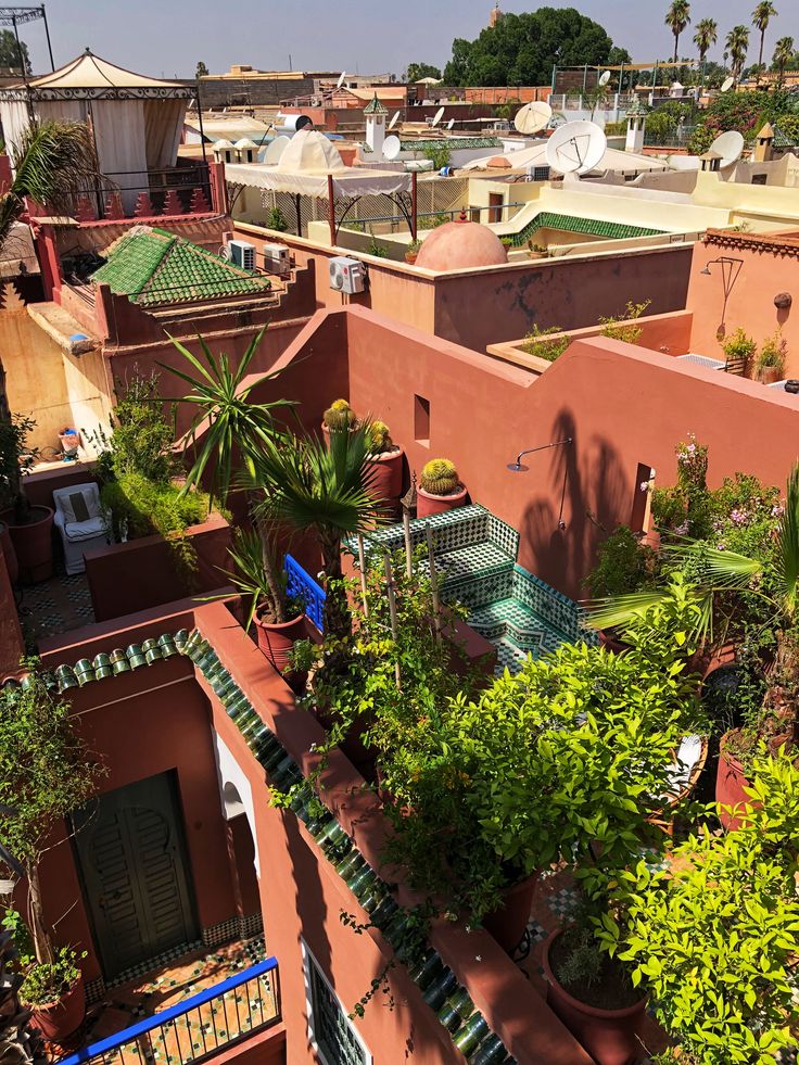 an aerial view of the rooftops and gardens in marraket village, morocco