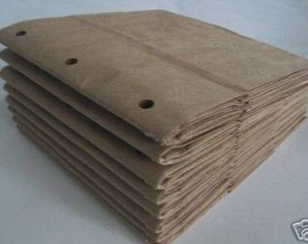 a stack of brown paper sitting on top of a white table next to each other