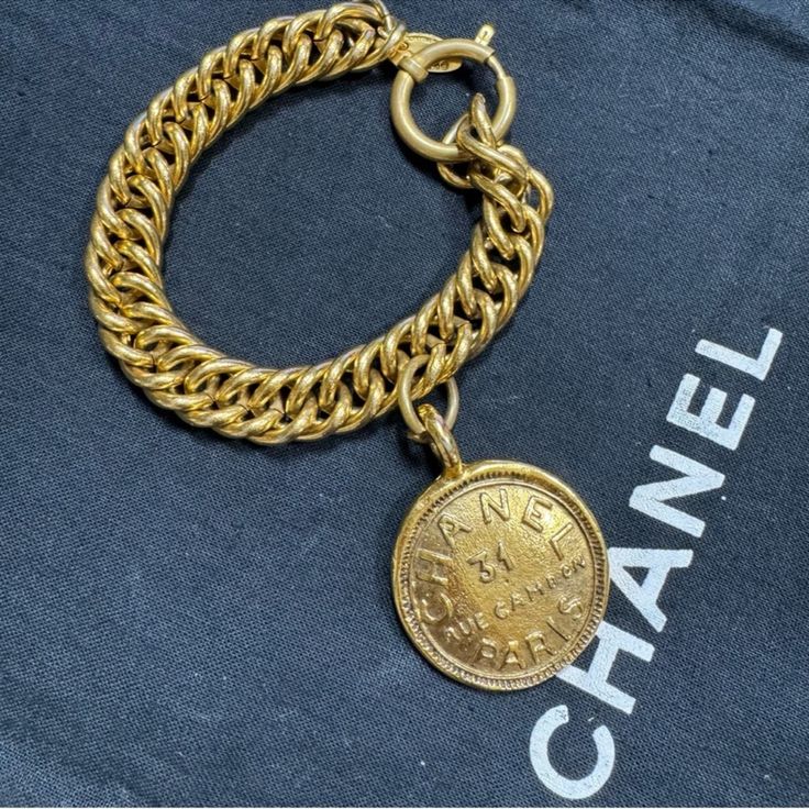 Vintage Chanel Bracelet From The Late 1970's - Early 1980's Collection 100% Authentic Made In France Gold Plated Excellent Condition Overall Aside From Light Wear And Scratches Throughout Metal Measurements Approx.: Inside Circumference: 8.5" Ornament-Length: 1.75" Ornament Width: 1.25" Comes With Box Luxury Chain Bracelet With Logo Charm, Luxury Yellow Gold Chain Bracelet With Logo Charm, Vintage Gold Bracelet With Logo Charm, Vintage Gold Jewelry Aaa Quality, Designer Gold-tone Logo Bracelets As Gift, 31 Rue Cambon, Chanel Bracelet, Chanel Jewelry, Vintage Chanel