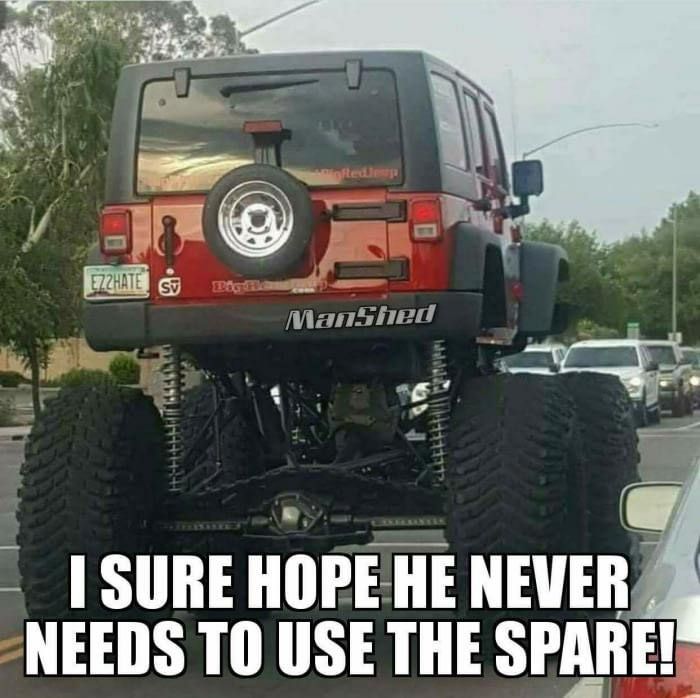 a red jeep parked on top of a parking lot