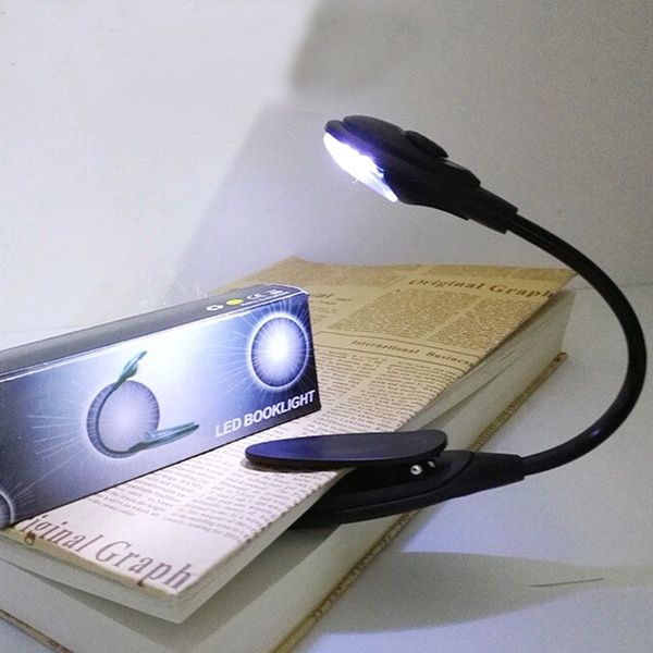 a book light sitting on top of a pile of books