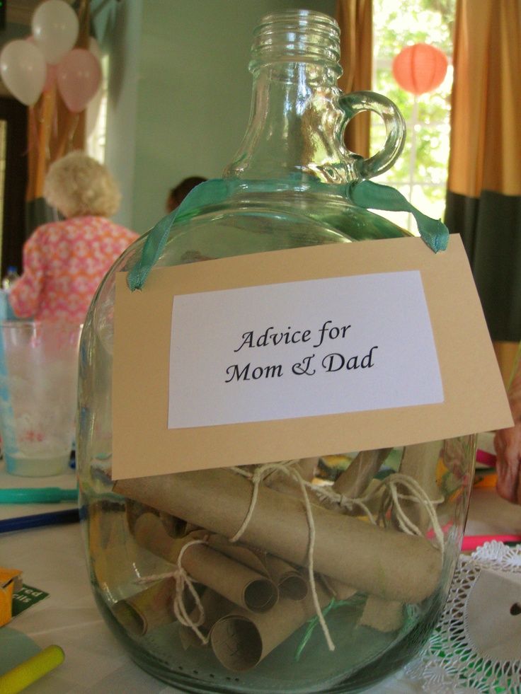 a glass bottle filled with lots of paper and twine on top of a table