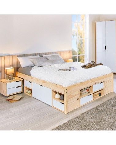 a bed with drawers underneath it in a room