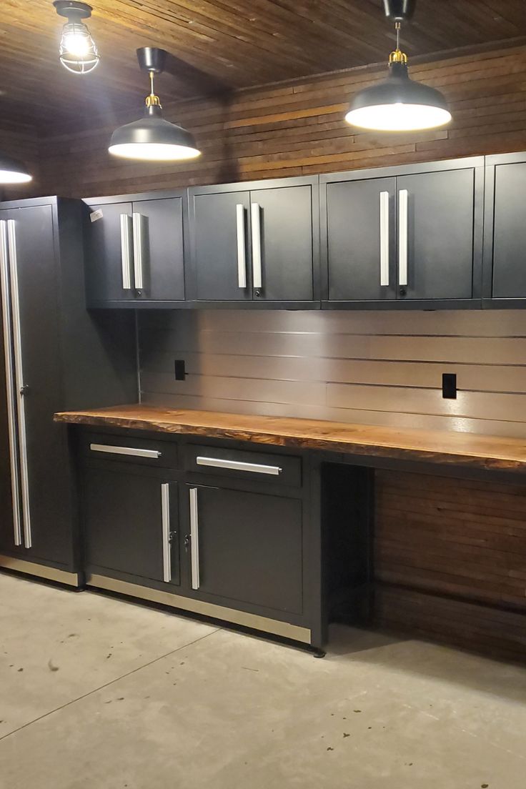 an empty garage with lots of cabinets and lights