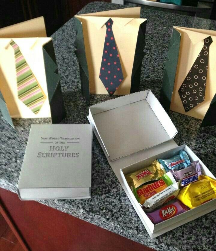 an assortment of ties and candy are sitting on the counter next to some gift bags