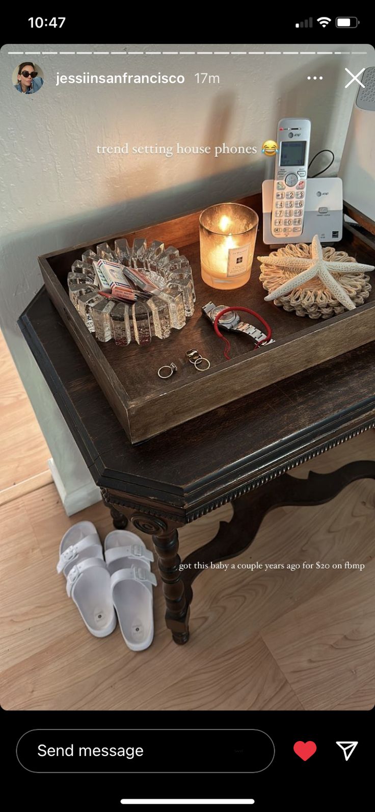 a cell phone sitting on top of a wooden table next to a pair of slippers