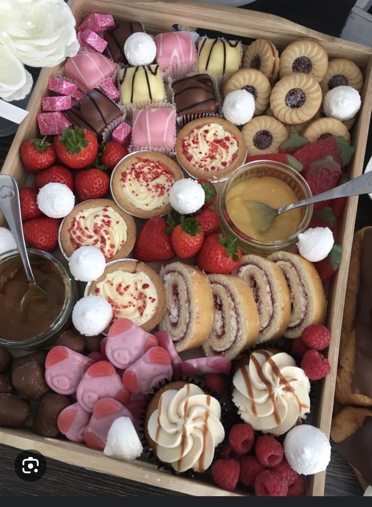 a box filled with lots of different types of desserts on top of a table