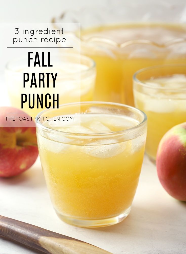 three glasses filled with fall party punch next to an apple and cinnamon stick on the table