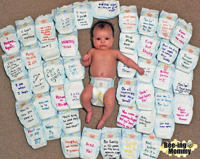 a baby laying on top of lots of diapers