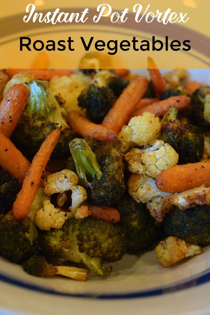 a white plate topped with broccoli carrots and cauliflower on top of a table