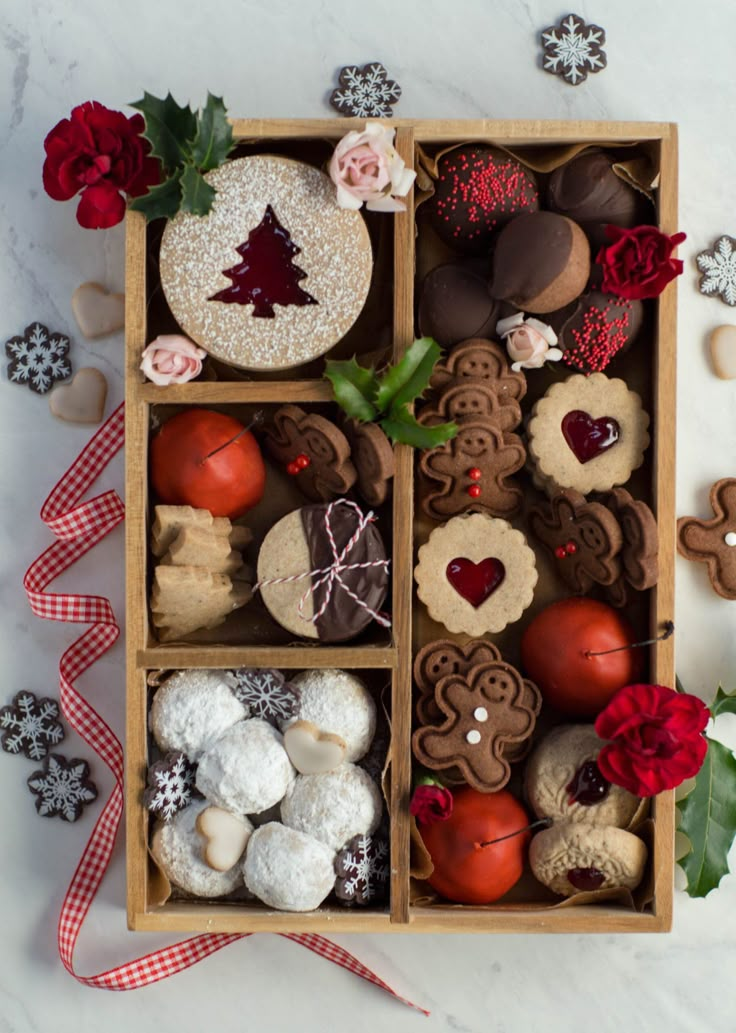 a box filled with lots of different types of cookies and pastries on top of a table