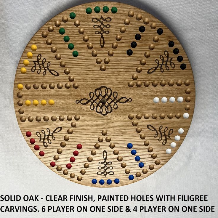 a wooden board game with many different colored dots and lines on it, along with the words sold oak - clear finish, painted holes with