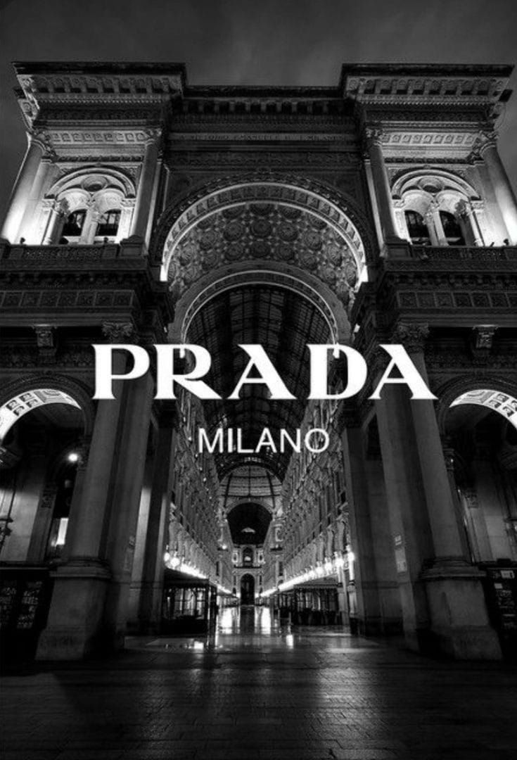 the words prada in front of an ornate building with columns and arches at night