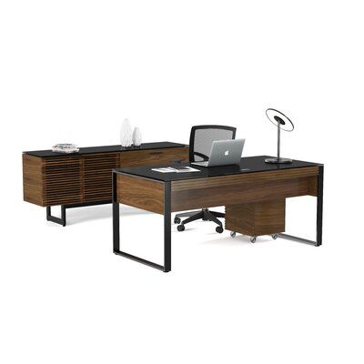 an office desk with two drawers and a laptop on it, in front of a white background