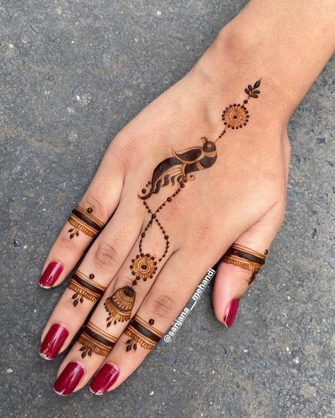 a woman's hand with henna tattoos on it