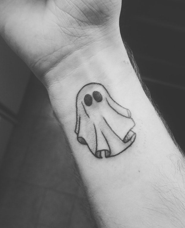 a small ghost tattoo on the wrist