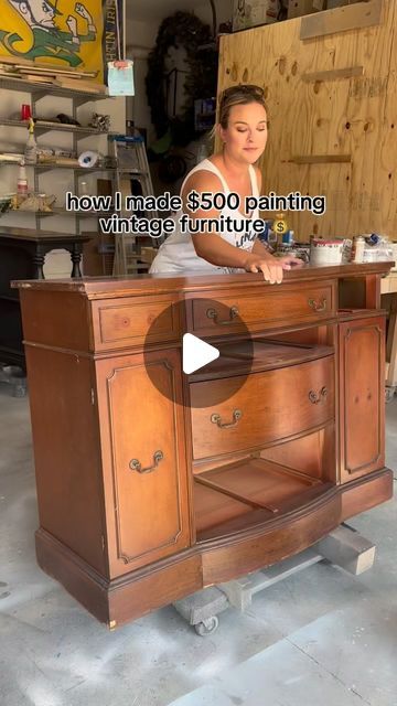 a woman standing behind a wooden cabinet in a shop with the words how i made $ 500 painting vintage furniture