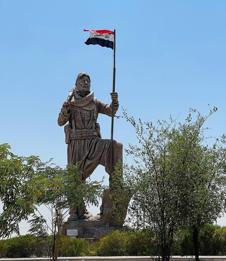 a statue of a man holding a flag