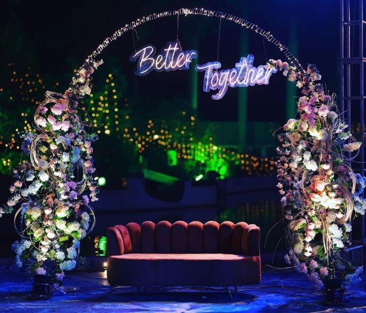 a stage decorated with flowers and lights