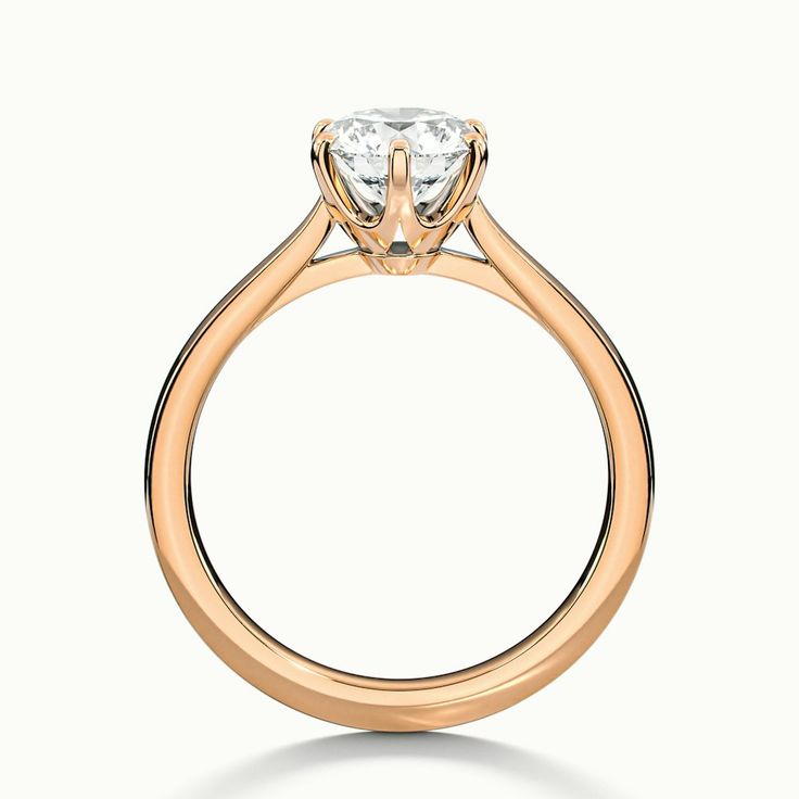 a gold engagement ring with a single diamond