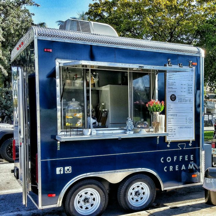 a food truck is parked on the side of the road with its door open and windows closed