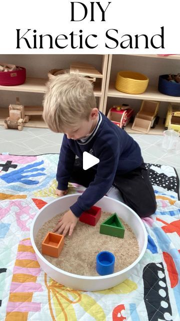 a little boy playing with sand in a bowl