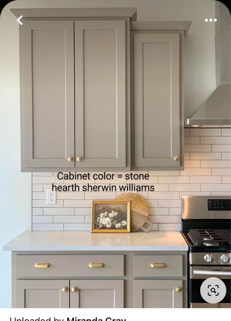 a kitchen with gray cabinets and white subway backsplash, labeled by amanda gray