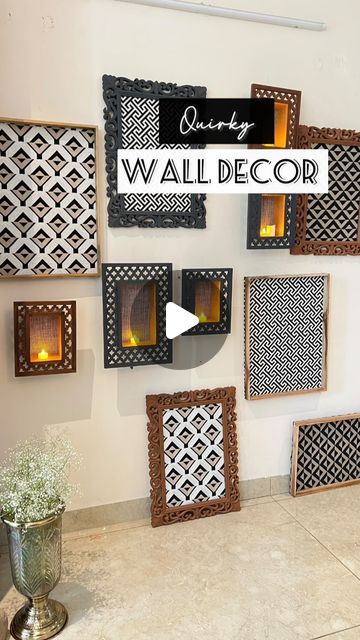 a wall decorated with wooden frames and candles