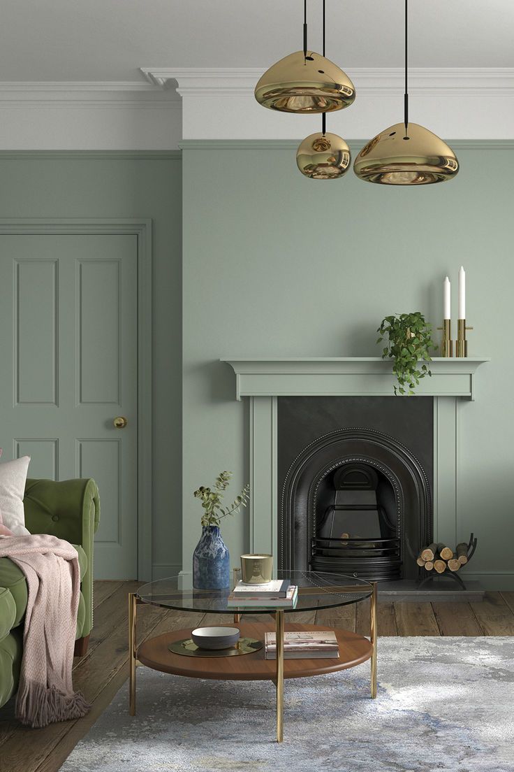 a living room with pink walls and gold accents on the ceiling, two chairs, a coffee table and a fireplace